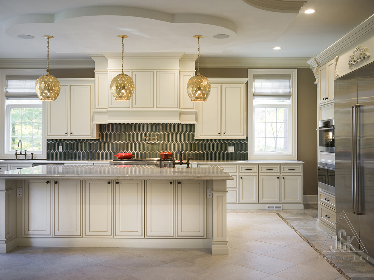 J&K kitchen featuring wood cabinetry, a large island and light countertops